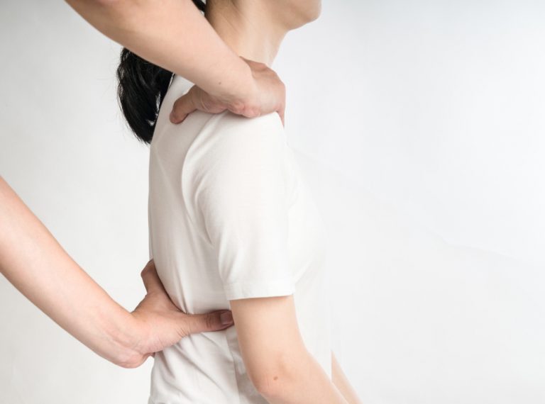 professional female physiotherapist giving shoulder massage man hospital 1